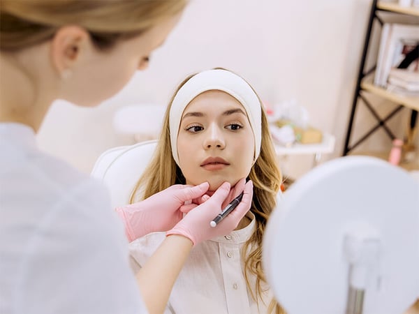 Woman receiving a consultation from an aesthetics expert